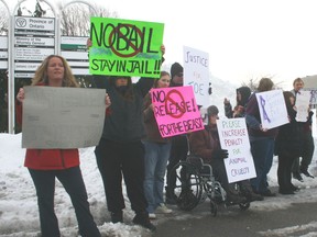 Nearly two dozen people rally outside Sarnia’s Court House asking for harsher penalties for people convicted of animal abuse. The group gathered as a 19-year-old accused of repeatedly shooting a cat name Joe with a pellet gun appeared in court for a bail hearing. HEATHER BROUWER/ SARNIA THIS WEEK/ QMI AGENCY