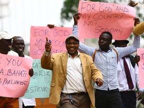 Ugandan anti-gay activist Pastor Martin Ssempa (C) leads anti-gay supporters as they celebrate after Uganda's President Yoweri Museveni signed a law imposing harsh penalties for homosexuality in Kampala February 24, 2014. REUTERS/Edward Echwalu