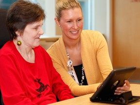 Susan Steele (left) and social worker Tracy Byrne use a tablet to view local long-term care facilities. Steele recently moved to long-term care after using video tours through the CCAC's Hospital to Home pilot program. (Submitted photo)