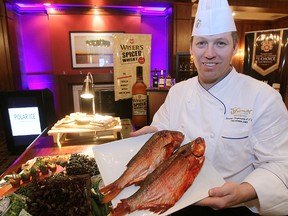 Jeremy Langemann, executive chef at the Fairmont Winnipeg, diplays smoked Goldeye during a press briefing in Winnipeg, Man. Monday February 24, 2014 for food that will be served during the Juno Awards.
Brian Donogh/Winnipeg Sun/QMI Agency