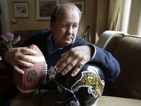Former Hamilton Tiger Cat owner George Grant with his Grey Cup helmet and ball but no Grey Cup ring Monday, February 24, 2014. Grant's Yorkville home was burglarized Feb. 9 and his 1999 championship ring stolen. (Craig Robertson/Toronto Sun)