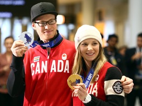 Silver medallist halfpipe skier Mike Riddle and gold medallist slopestyle skier Dara Howell return home from the 2014 Sochi Olympic Winter Games at Pearson International Airport in Toronto on Monday, February 24, 2014. (Dave Abel/Toronto Sun)
