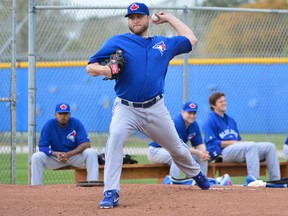 Blue Jays pitcher Mark Buehrle warms up with some throws in the bullpen yesterday at the Bobby Mattick Training Center. (TOMMY GILLIGAN/USA TODAY SPORTS)