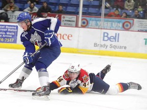 Gino Donato/The Sudbury Star
Erie Otters Travis Dermott tries to trip up Sudbury Wolves Ray Huether during a drive to the net during first period OHL action from the Sudbury Community Arena on Monday night.