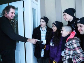 Gino Donato/The Sudbury Star
College Notre Dame students canvassed the city last week to raise money for the Northern Cancer Foundation. More than $26,000 was collected. J.C. Marcotte makes a donation to student council members Nicolas Despatie, Sabine Bouchard, Danyelle Lamontagne, Benjamin Doudard and Carl Aho.