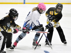 Danielle Vogels (left) and Samantha McCarthy of the Mitchell U12 ringette team double-team this Goderich opponent during Western Regional Ringette League (WRRL) action last Thursday, a 7-4 loss. ANDY BADER/MITCHELL ADVOCATE