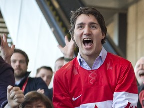 Liberal leader Justin Trudeau celebrates the victory of Canada's olympic men's hockey team at a Liberal convention in Montreal on February 23, 2014. (JOEL LEMAY/QMI AGENCY)