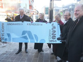 From the left; Manitoba Premier Greg Selinger, Melanie Berry, President & CEO CARAS/The Juno Awards & MusiCounts, Carole Vivier, of the 2014 Juno Host Committee, Mayor Sam Katz and Kenny Boyce, of the 2014 Juno Host Committee, display a Juno Banner on Portage Ave in  Winnipeg. (Chris Procaylo/Winnipeg Sun)