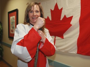 Monique Hamelin poses with her favourite 1972 Team Canada hockey jersey on Tuesday. Hamelin travelled to Sochi, Russia for the 2014 Winter Olympic Games. TREVOR ROBB/Edmonton Sun)