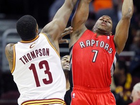 Toronto Raptors point guard Kyle Lowry (7) grabs a rebound against Cleveland Cavaliers power forward Tristan Thompson (13) during the first quarter at Quicken Loans Arena in Cleveland. (RON SCHWANE/USA TODAY Sports)