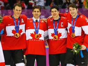 Canada's (left to right) Jonathan Toews, John Tavares, Sidney Crosby and Matt Duchene pose with their gold medals following their win over Sweden at the Sochi Olympics February 23, 2014. (REUTERS/Brian Snyder)