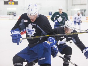 Dion Phaneuf (left) and Jake Gardiner battle during Leafs practice at the MasterCard Centre yesterday. (Ernest Doroszuk/Toronto Sun)