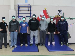 Seven subjects out of 13 participating in Defence Research and Development Canada's Arctic Circadian Rhythm Sleep study at Canadian Forces Station Alert in the Arctic are seen with their luminescent green visors in the station's gymnasium last month. - Photo by Lt. Irina Jakhovets