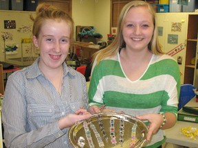 Jacklyn Janssen, left, and Chelsea Dean both enjoyed helping run a company this year through Junior Achievement. They were part of a company called Eco Links, which makes bracelets out of recycled materials.