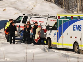 Emergency officials carry a seven month-old baby down the driveway of 6720 Township Road 720 near Grovedale, Alberta on Tuesday, Feb 25, 2014. A the baby was left at the house by a person who had stolen a pickup truck from Grande Prairie, Alberta earlier that day.  TOM BATEMAN/DAILY HERALD-TRIBUNE