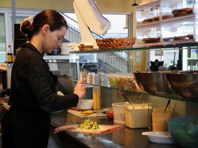 Sara Scott-Buccleuch prepares fresh menu items at Y'Wanna Hav A Cafe in Century Place. The small business would be exempt from proposed legislation regarding posting calories on menus.  
Janet Richards/The Intelligencer