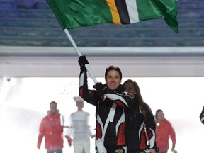 Dominica's flag bearer, cross-country skier Gary di Silvestri, leads his national delegation during the opening ceremony of the 2014 Sochi Winter Olympics February 7, 2014 in Sochi. (AFP PHOTO/ANDREJ ISAKOVIC)