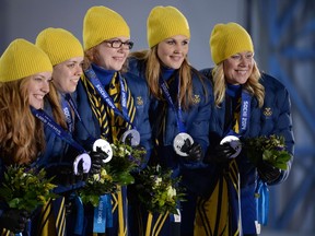 (From left) Canadian gold medallists Kirsten Wall, Dawn McEwen, Jill Officer, Kaitlyn Lawes, and Jennifer Jones pose during the Women's Curling Medal Ceremony at the Sochi medals plaza last week. Not all of us can be Olympic stars, but the measure of a person's life shouldn't be dependent on that, either. (AFP PHOTO/PETER PARKS