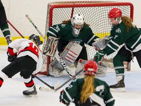 Medway's Lauren Straatman scores on Mother Teresa's goalie Carley Molnar making the score 3-1 in the third period of their AAA/AAAA city final game in Komoka on Wednesday February 26, 2014. (MIKE HENSEN, The London Free Press)
