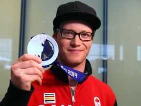 Silver medalist, halfpipe skier Mike Riddle returns from the 2014 Sochi Olympic winter games at Pearson International Airport in Toronto on Monday February 24, 2014. Dave Abel/Toronto Sun