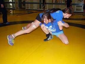 Central Elgin wrestler Rowan Miller (bottom) practices a hold with Parkside competitor Cobie Gregory at a recent practice in the Central Elgin cafeteria. Both have qualified for the OFSAA provincial wrestling championship next week. (Ben Forrest, Times-Journal)