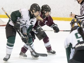 Captains Shelby Perry of the Holy Cross Crusaders, left, and Erika Lynn Nolan of the Frontenac Falcons jostle for the puck in the faceoff circle during their Kingston Area Secondary Schools Athletic Association girls hockey semifinal Wednesday at the Invista Centre. Holy Cross won the game 5-0. (Tim Gordanier/The Whig-Standard)