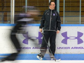 Mustangs head coach Clarke Singer watches the team during practice this week at Western?s Thompson arena. Singer expects Western?s next playoff opponent, Windsor, to play a physical game. (MIKE HENSEN, The London Free Press)