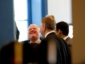 Toronto Mayor Rob Ford laughs during a break in the Big City Mayors' Caucus in Ottawa on Wednesday, February 26, 2014. (Errol McGihon/QMI Agency)