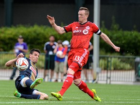 Toronto FC defender Steven Caldwell (right) attempts to get the ball past Philadelphia Union forward Sebastien Le Toux during the first half of a pre-season game in Lake Buena Vista, Fla., on Feb. 26, 2014. The game ended in a 0-0 draw. (JONATHAN DYER/USA Today Sports)