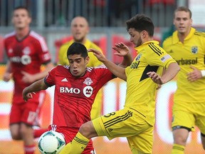 Matias Laba (left) tries to fight for control of the ball with Columbus Crew midfielder Matias Sanchez (8) during an MLS game at BMO Field in Toronto on May 18, 2013. Toronto FC dealt Laba to the Vancouver Whitecaps on Feb. 26, 2014. (JACK BOLAND/Toronto Sun)