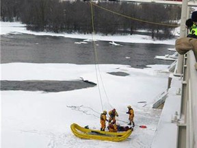 Firefighters from Gatineau rescue a person from the ice and frigid waters of the Ottawa River on Thursday, Feb. 27, 2014. The victim had no vital signs when they were pulled from amongst the ice and freezing waters. (OTTAWA FIRE DEP'T image)