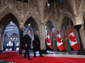 Canada's Prime Minister Stephen Harper (R) walks with the Aga Khan, spiritual leader of Ismaili Muslims, in the Rotunda on Parliament Hill in Ottawa February 27, 2014. REUTERS/Chris Wattie