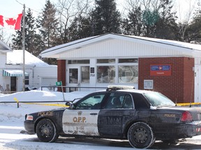 An OPP officer keeps an eye on the post office in Tamworth, Ont., on Thursday morning. (Meghan Balogh/QMI Agency)