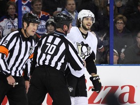 Pittsburgh defenceman Kris Letang (58) is called for a penalty after hitting forward Mark Arcobello (26) in the first period of a NHL game as the Edmonton Oilers play the Pittsburgh Penguins at Rexall Place in Edmonton, Alta., on Friday, Jan. 10, 2014. (Ian Kucerak/QMI Agency)