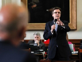 Texas state Republican Senator Dan Patrick (R) speaks as state Democratic Senator John Whitmire (L, in foreground) listens during a meeting of the state Senate to consider legislation restricting abortion rights in Austin, Texas July 12, 2013. (REUTERS/Mike Stone)