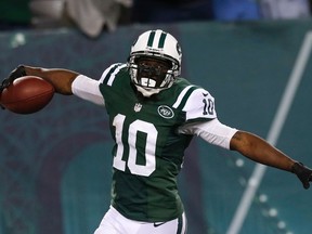 New York Jets wide receiver Santonio Holmes celebrates a touchdown reception in the second half against the Buffalo BIlls during their NFL football game in East Rutherford, New Jersey, September 22, 2013. (REUTERS/Mike Segar)