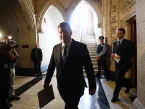 Canada's Foreign Minister John Baird (C) arrives at a news conference with Immigration Minister Chris Alexander in the foyer of the House of Commons on Parliament Hill in Ottawa January 28, 2014. REUTERS/Chris Wattie
