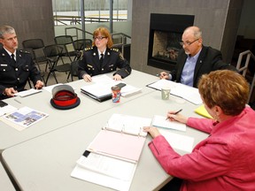 Chief of Belleville police Cory McMullan and deputy chief Paul Vandegraaf, left, are seen with some members of Belleville Police Service Board during a meeting held in the 'Fireplace Room' at Quinte Sports and Wellness Centre in Belleville Thursday. 
JEROME LESSARD/The Intelligencer