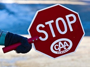 FILE PHOTO: A crosswalk patrol holds a stop sign during an Edmonton Police Service press event about congested traffic flow in school zones at Westbrook School in Edmonton, Alta., on Thursday, Feb. 6, 2014. Codie McLachlan/Edmonton Sun/QMI Agency
