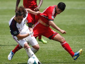 Matias Laba (right), now a member of the Vancouver Whitecaps, started 16 games for Toronto FC last year. (Craig Robertson/Toronto Sun)