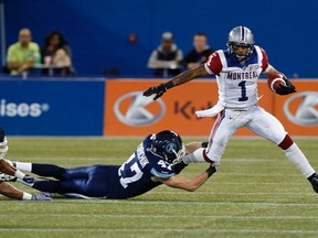 James Yurichuck of the Toronto Argonauts tackles Arland Bruce of the Montreal Alouettes during CFL action in Toronto Friday, November 1, 2013. (STAN BEHAL/QMI Agency)