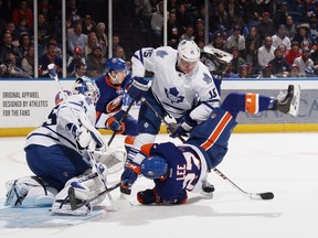 Maple Leafs' Paul Ranger trips up Islanders' Anders Lee during the second period at the Nassau Veterans Memorial Coliseum in Uniondale, N.Y., last night. (GETTY IMAGES)