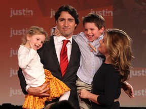 Federal Liberal leader Justin Trudeau holds his two children Xavier and Ella-Grace as they wave to the crowd with his wife Sophie Gregoire in this April 14, 2013, file photo. (JOHN MAJOR/QMI AGENCY)