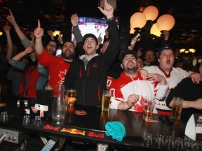 Edmontonians cheer on Team Canada at The Pint pub during the Olympic gold medal game.