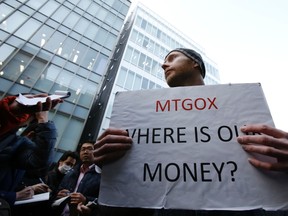 Kolin Burges, a self-styled cryptocurrency trader and former software engineer from London, holds a placard to protest against Mt. Gox, in front of the building where the digital marketplace operator was formerly housed in Tokyo.

REUTERS/Toru Hanai