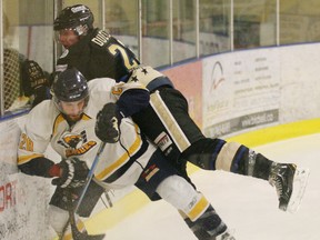 The Eagles Matt York managed to duck out of the way just in time as Colin Dueck of the Bentley Generals finds more boards than body with this attempted bodycheck in their final playoff game. - Gord Montgomery, Reporter/Examiner