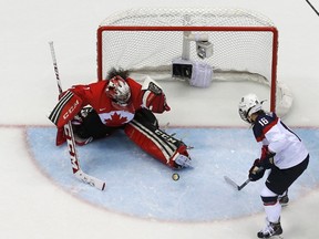 Canada?s goalie Shannon Szabados makes a save in overtime as Team USA?s Lyndsey Fry looks for a rebound during their women?s ice hockey gold medal game at the Sochi 2014 Winter Olympic Games last week. (Mark Blinch/Reuters)