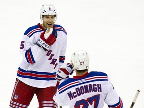 New York Rangers defenceman Dan Girardi celebrates with teammate Ryan McDonagh during NHL action against the Columbus Blue Jackets at Nationwide Arena Nov. 7, 2013. (Trevor Ruszkowksi/USA TODAY Sports)