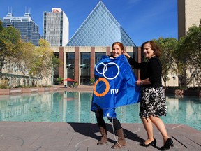 According to her mother Sheila, Edmonton triathlete Paula Findlay, shown here posting with the ITU flag with Coun. Jane Batty, is training following a series of frustrating injuries following a rookie campaign that saw her win five ITU events. (David Bloom, Edmonton Sun)