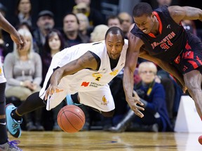 Elvin Mims of the London Lightning dives for a loose ball while guarding Flenard Whitfield of the Brampton A's during their game at Budweiser Gardens in London, Ont. on Thursday January 9, 2014. 
(Mike Hensen, The London Free Press)